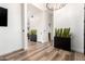 Open hallway featuring wood-look floors and modern plant accents that bring the space to life at 6518 W Louise Dr, Glendale, AZ 85310