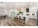 Modern kitchen with a large island, pendant lighting, and white cabinetry at 6518 W Louise Dr, Glendale, AZ 85310