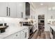 Modern kitchen features quartz counters, stainless steel appliances, and a walk-in pantry for ample storage at 6518 W Louise Dr, Glendale, AZ 85310