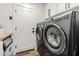 Laundry room features modern washer and dryer set with ample storage space and adjacent sink at 6518 W Louise Dr, Glendale, AZ 85310