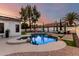 Beautiful backyard featuring a pool, spa, lounge chairs, and a lush green lawn at 6518 W Louise Dr, Glendale, AZ 85310