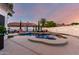 Inviting backyard pool with rock features, string lights, and manicured landscaping for relaxed outdoor living at 6518 W Louise Dr, Glendale, AZ 85310