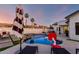 Inviting pool area with lounge chairs, umbrellas, and a basketball hoop at 6518 W Louise Dr, Glendale, AZ 85310
