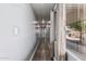 Hallway with wood floors, light gray walls, recessed lights, and a window to the outside at 6812 N Polk St # 223, Phoenix, AZ 85043