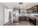 Modern kitchen with stainless steel appliances, wooden cabinets, and a pantry at 6812 N Polk St # 223, Phoenix, AZ 85043