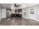 Bright open-plan living and kitchen area with dark wood floors and modern finishes at 6812 N Polk St # 223, Phoenix, AZ 85043