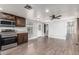 The living room features wood floors, neutral wall colors and view to kitchen and entry at 6812 N Polk St # 223, Phoenix, AZ 85043