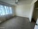 Simple bedroom features neutral carpeting, a ceiling fan, and a window, making it a comfortable and adaptable space at 6832 W Vogel Ave, Peoria, AZ 85345
