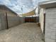 Side yard with gravel landscaping and a shade structure, creating a functional and low-maintenance outdoor area at 6832 W Vogel Ave, Peoria, AZ 85345