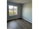 Cozy bedroom featuring a window with neighborhood views and ample natural light at 7007 S 45Th Pl, Phoenix, AZ 85042