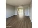 Spacious living room with new wood flooring and archway leading to backyard at 7007 S 45Th Pl, Phoenix, AZ 85042