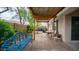 Paver patio in the backyard with a pergola, seating, a concrete block, lush greenery, and neighboring houses in the background at 726 E Rose Marie Ln, Phoenix, AZ 85022