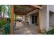 Backyard features a paver patio with a pergola, seating, lush greenery, and a glimpse of neighboring houses at 726 E Rose Marie Ln, Phoenix, AZ 85022