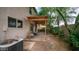 Paver patio with pergola and seating, an AC unit, desert landscaping, and a view of the neighboring houses and green space at 726 E Rose Marie Ln, Phoenix, AZ 85022