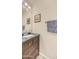 The bathroom offers a dark wood vanity, framed artwork, and a silver faucet and hardware at 726 E Rose Marie Ln, Phoenix, AZ 85022
