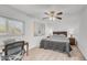 Bright bedroom with a ceiling fan, painting, and a desk by the window at 726 E Rose Marie Ln, Phoenix, AZ 85022