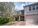 Tan two-story home with desert landscaping in the front, including a tree and pathway leading to the front door at 726 E Rose Marie Ln, Phoenix, AZ 85022