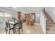 An open kitchen has an island with stools, wood cabinets, and a breakfast table next to the stairs at 726 E Rose Marie Ln, Phoenix, AZ 85022