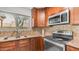 The kitchen features wood cabinets, granite countertops, stainless steel appliances, and mosaic backsplash at 726 E Rose Marie Ln, Phoenix, AZ 85022