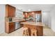 This kitchen offers stainless steel appliances, wood cabinetry, granite countertops, and tiled backsplash at 726 E Rose Marie Ln, Phoenix, AZ 85022