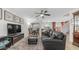 Open-concept living room featuring a ceiling fan, leather seating, and a dining area leading into the kitchen at 726 E Rose Marie Ln, Phoenix, AZ 85022
