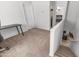 A carpeted loft space with a small desk and view of the stairs and other bedrooms at 726 E Rose Marie Ln, Phoenix, AZ 85022