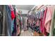 A well-organized walk-in closet with clothing, shoes, and storage at 726 E Rose Marie Ln, Phoenix, AZ 85022