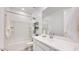 Bright bathroom featuring a tub, sleek vanity, white cabinets, and modern fixtures at 7842 W Tether Trl, Peoria, AZ 85383