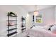 Stylish bedroom featuring shelving, a decorative light fixture, and plenty of natural light at 7842 W Tether Trl, Peoria, AZ 85383