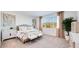 Bright bedroom featuring neutral tones, stylish furniture, modern décor, and plenty of natural light at 7842 W Tether Trl, Peoria, AZ 85383