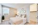 Calming bedroom featuring a large window, plush bedding, and plenty of natural light at 7842 W Tether Trl, Peoria, AZ 85383