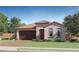 Charming one-story home featuring a tile roof, two-car garage, and a well-manicured lawn at 7842 W Tether Trl, Peoria, AZ 85383