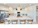 Modern kitchen featuring a large island, stainless steel appliances, and elegant pendant lighting at 7842 W Tether Trl, Peoria, AZ 85383