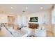 Bright and airy living room with neutral tones, a large TV, and comfortable seating arrangements at 7842 W Tether Trl, Peoria, AZ 85383