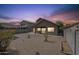 Gravel backyard featuring a covered patio, low-maintenance landscaping, and block wall fence at 7937 W Chickasaw St, Phoenix, AZ 85043