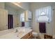Traditional bathroom with a wide mirror, vanity, toilet, cabinet and shower-tub combination at 7937 W Chickasaw St, Phoenix, AZ 85043