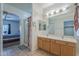 Bright bathroom boasts dual sinks, a large mirror, and a separate shower and toilet area at 7937 W Chickasaw St, Phoenix, AZ 85043