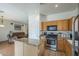 Well-lit kitchen featuring an island, stainless steel appliances, and convenient access to living area at 7937 W Chickasaw St, Phoenix, AZ 85043