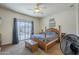 Serene main bedroom with a ceiling fan, carpeted floors, and access to a private patio at 7937 W Chickasaw St, Phoenix, AZ 85043