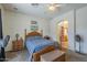 Comfortable main bedroom featuring a ceiling fan, neutral decor, and an ensuite bathroom at 7937 W Chickasaw St, Phoenix, AZ 85043