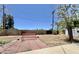 Expansive backyard showcasing a patio, vibrant red bench, mature tree, and block fence, offering a private retreat at 8502 N 26Th Ave, Phoenix, AZ 85021