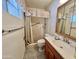 Neutral bathroom featuring a shower with tiled walls, grab bar, and shower curtain at 8502 N 26Th Ave, Phoenix, AZ 85021