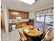 Bright kitchen showcasing wood cabinetry, an eat in area, tile flooring, and a window overlooking the backyard at 8502 N 26Th Ave, Phoenix, AZ 85021