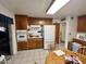 The kitchen has wood cabinets, tiled floors, and appliances including a stove, oven, and refrigerator at 8502 N 26Th Ave, Phoenix, AZ 85021