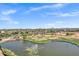 Aerial view of community golf course with lake and fountain at 110 E Saddle Way, San Tan Valley, AZ 85143
