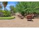 Landscaped backyard featuring a putting green and seating area at 110 E Saddle Way, San Tan Valley, AZ 85143