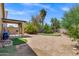Gravel backyard with putting green and covered patio at 110 E Saddle Way, San Tan Valley, AZ 85143