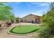 Well-maintained backyard featuring a putting green and ample seating at 110 E Saddle Way, San Tan Valley, AZ 85143