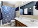 Bathroom with double sinks and stylish blue patterned shower curtain at 110 E Saddle Way, San Tan Valley, AZ 85143