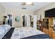 Bright bedroom featuring a cozy bed, an entertainment center, and closet/bathroom access at 110 E Saddle Way, San Tan Valley, AZ 85143